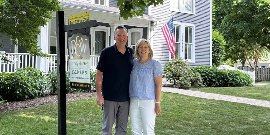 Mark and Elaine standing in front of their Naperville home. May 2023 